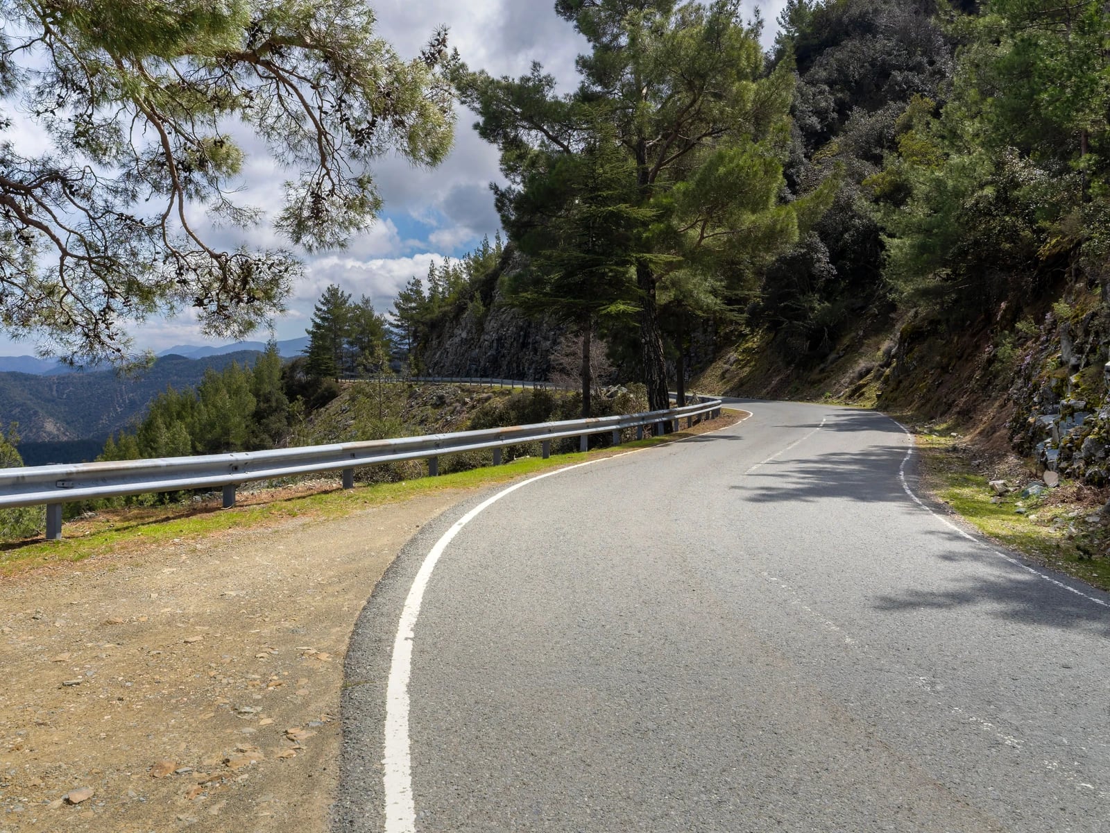 A winding mountain road through the Troodos Mountains in Cyprus